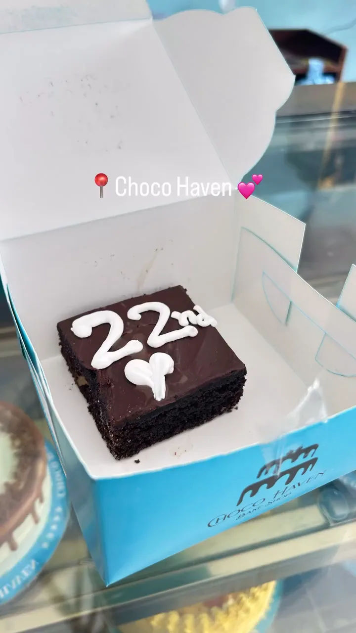 A chocolate cake in a Choco Haven blue box